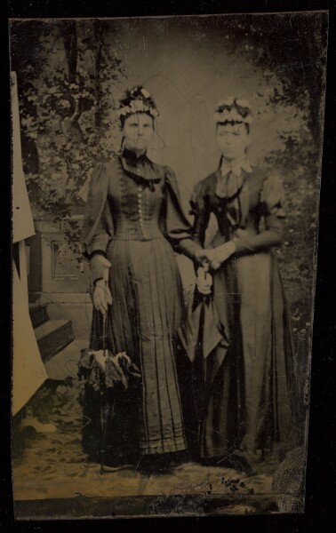 Unknown, [Two unidentified women, standing, both wearing hats and holding parasols]