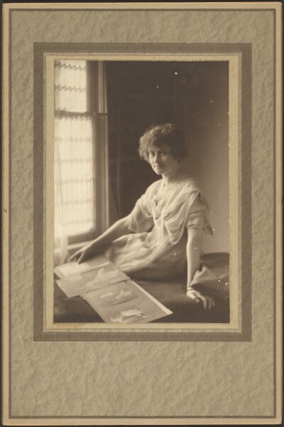 Louis Fleckenstein, [Portrait of a Woman Looking at Album]