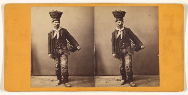 Unknown, [Man standing, smoking pipe, with basket on head and another under one arm]