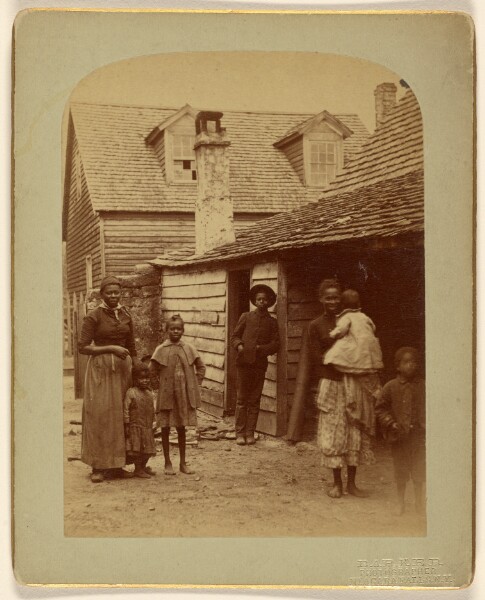 George Barker, [Portrait of a Black family standing in front of a house]