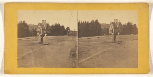 Unknown, [Two women walking down street with backs to camera, large house in background]