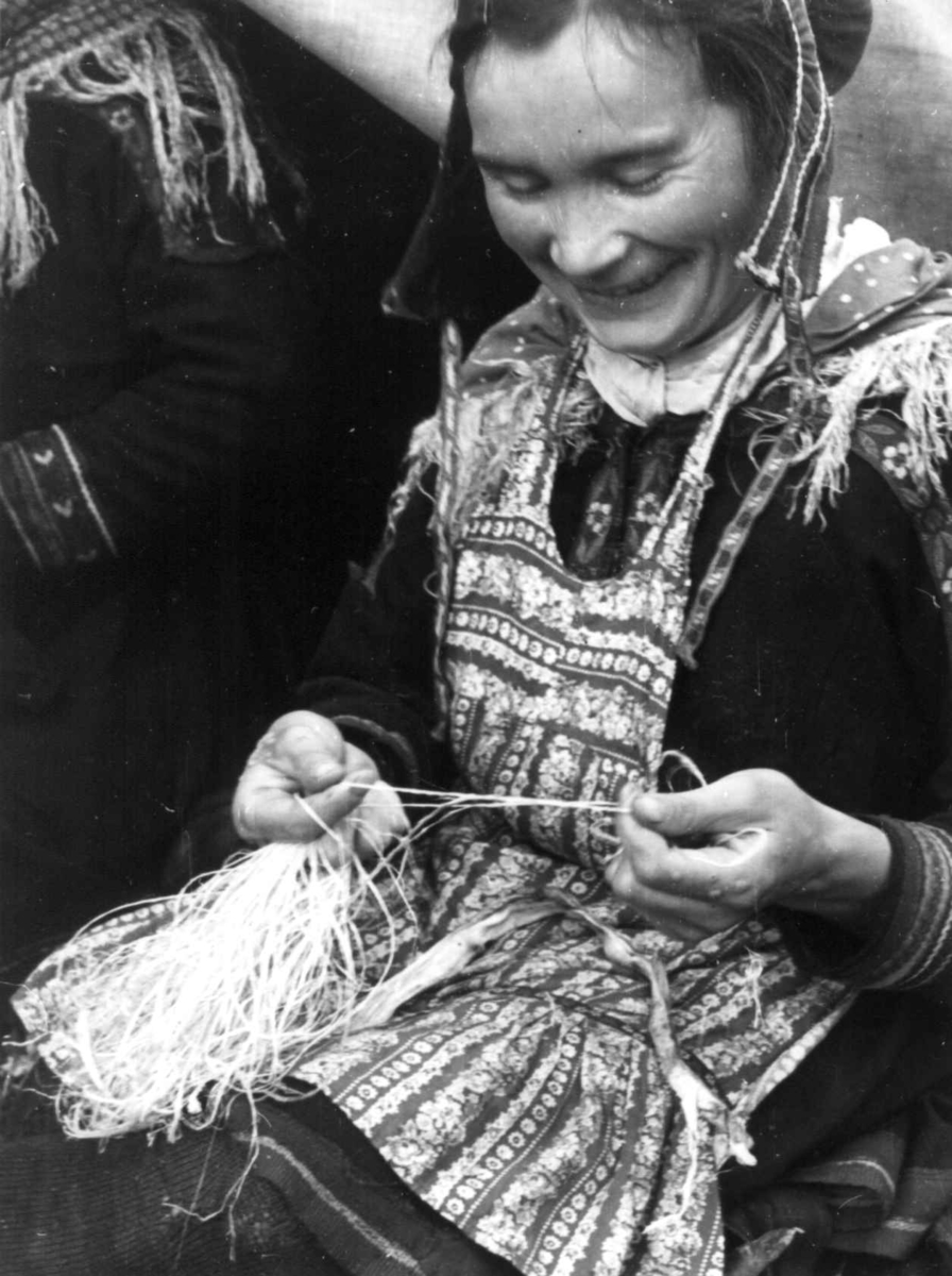 Anna Grostøl, En kvinne bearbeider senetråd. Olderdalen, Kåfjord, Troms 1947.