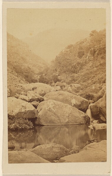 Unknown, [View of an unidentified mountain area with rocks and stream]