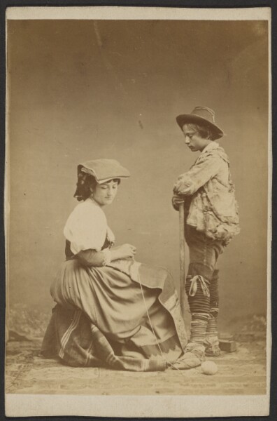 Unknown, [Woman sewing while boy watches]