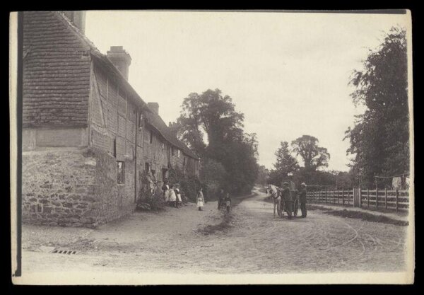 Gale, Lt. Col. Joseph, Two men, a horse and children outside a row of houses