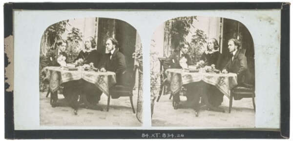 Unknown, [Unidentified British man, woman and young boy seated at a table which is covered with books and other objects including a bust]