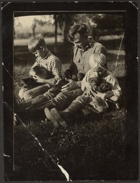 Louis Fleckenstein, [Man with Children and Puppies in Yard]