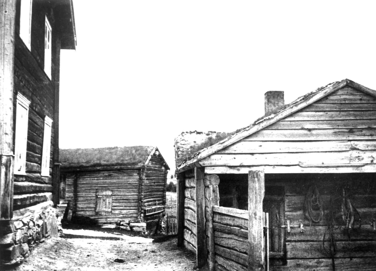 Anna Grostøl, Antagelig Lesja, Oppland 1934. Gårdstun med tre-bygninger.