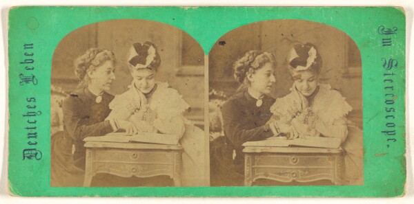 Unknown, [Mother and daughter looking at a book, leaning on a table]