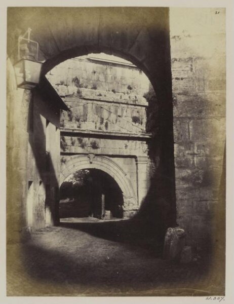 Parker, John Henry, Gates of Rome and Aqueducts - Arch of Augustus at the Porta Tiburtina, with two inscriptions of the Aqueducts, one of Augustus, B.C. 3, the other of repairs by Caracalla, A.D. 212, the Aqueducts Marcia, Tepula, and Julia over it (the jambs of the arch are buried by the filling up of the foss-way)