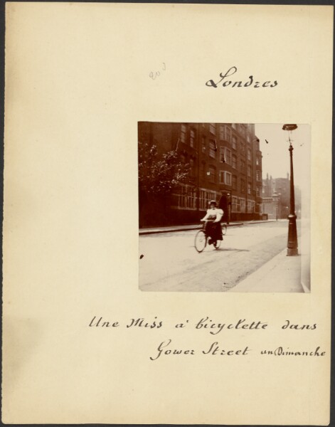 Unknown, [Young woman riding bicycle on Gower Street]