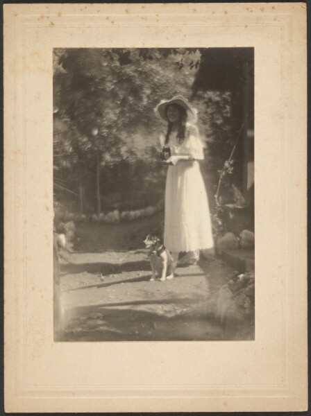 Louis Fleckenstein, [Woman with Camera and her Dog]