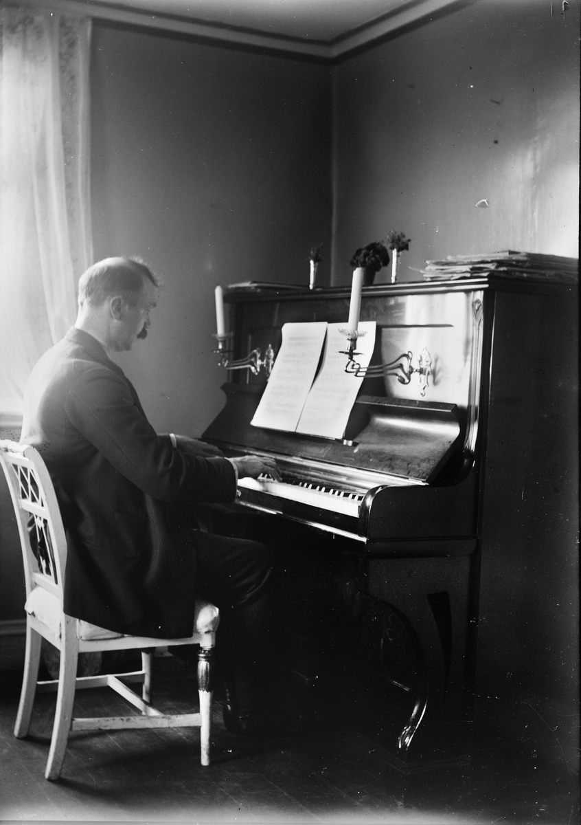 Okänd,, The composer Ruben Liljefors plays piano likely in the home, Sweden