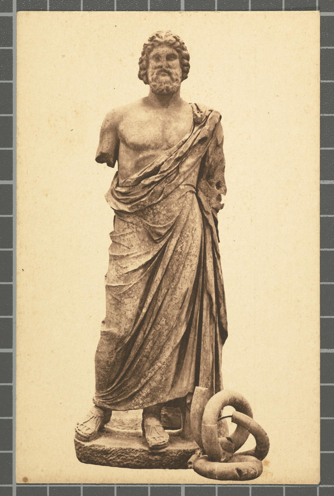 Desconegut, Sèrie 1.ª - N.º 9 Emporion (Empúries-L'Escala) - Estàtua de marbre del déu de la medicina Asclepi (Esculapi). Fou trobada en el seu temple d'Empúries.