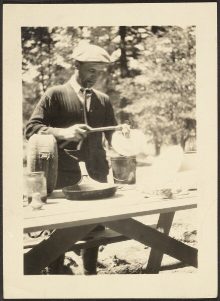 Louis Fleckenstein, [Man Standing at Picnic Table]