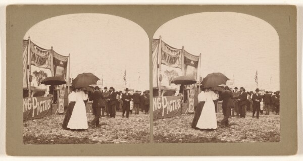 Unknown, [Fairgrounds: people at the venues, some women walking with umbrellas]