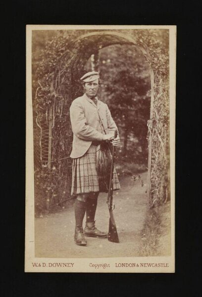 W. & D. Downey, A portrait of a man holding a gun