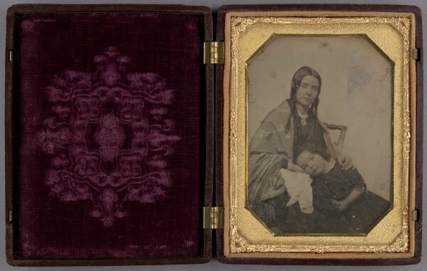 Unknown, [Little girl resting her head in her seated mother's lap]