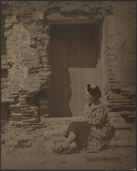 Louis Fleckenstein, [Woman Seated Before Deteriorating Building]