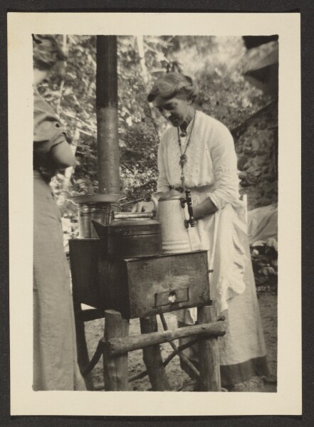 Louis Fleckenstein, [Woman Using Outdoor Stove]