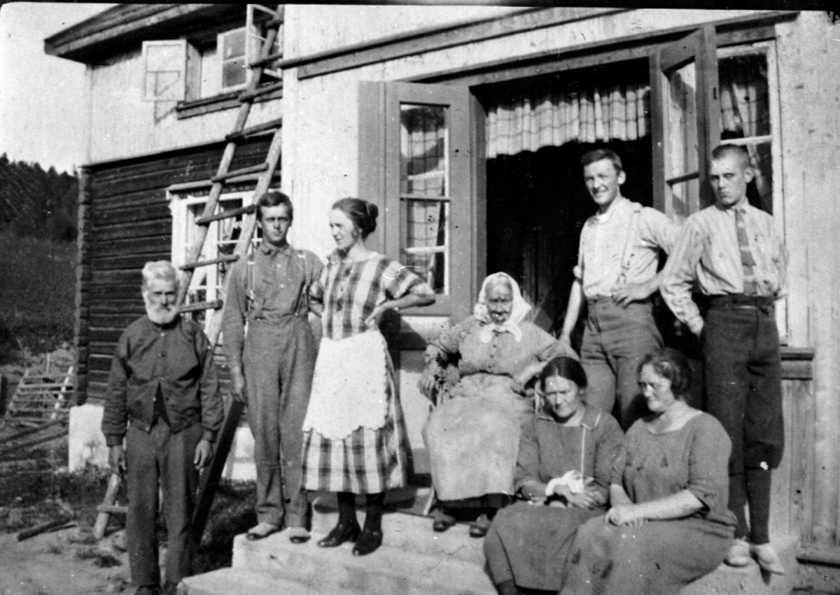 Anno Domkirkeodden, Familien Sandbæk ute foran hovedbygningen på Raknerud nordre, Helgøya. Fra venstre er Retinius Raknerud (1853-1925), Bjarne Olsen Sandbæk (1902-1979), Alvhild Raknerud f.1905, Anne Marie Raknerud (1843-1932), 2 slektninger. Sittende foran er Magda (1884-1953), Emma.