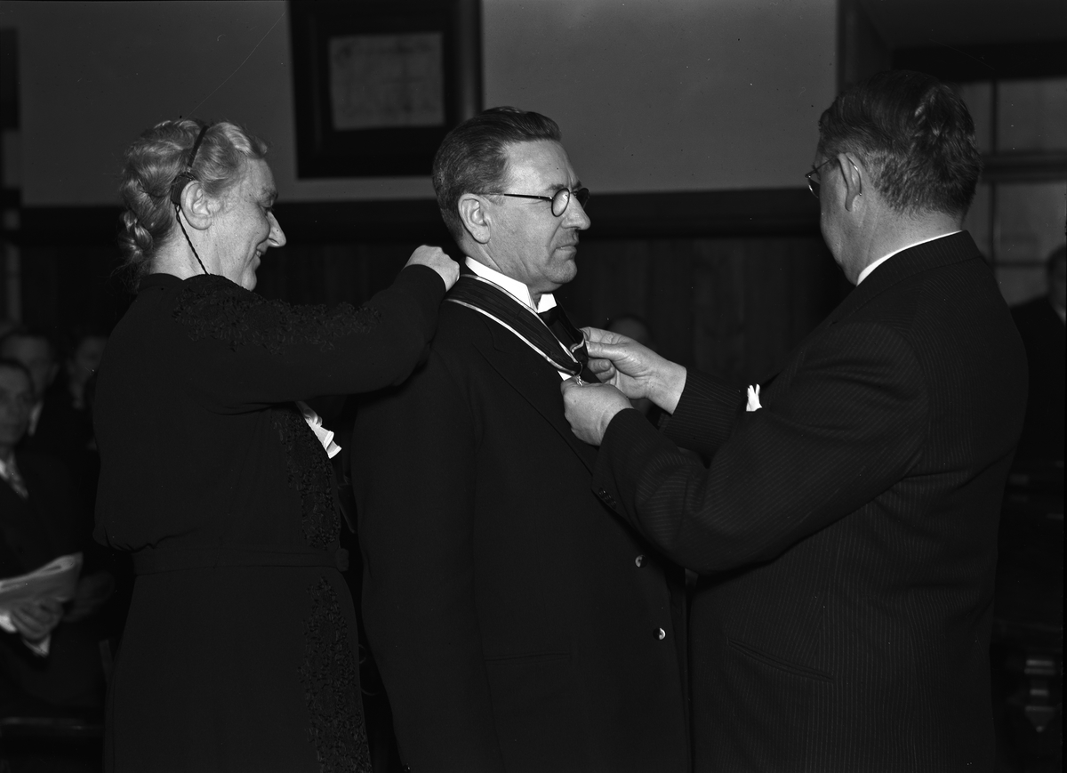 Paul Sandberg, Man får medalj av landshövding Hilding Kjellman, med assistans av kvinna. Uppsala i april 1945