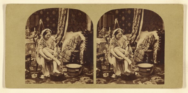 London Stereoscopic and Photographic Company, [Woman seated, pulling on her stocking]