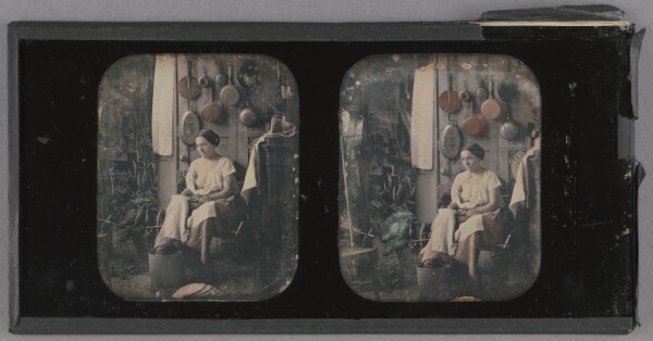 Unknown, [Woman seated in a kitchen with one breast exposed]