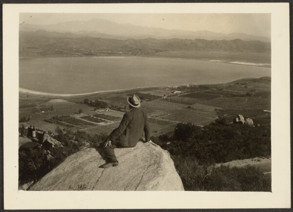 Louis Fleckenstein, [Man on Rock Promontory Overlooking Farmland]