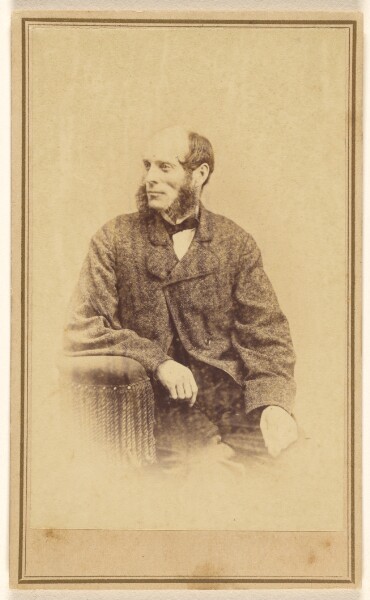 Alexander Gardner, [Unidentified man with long, bushy muttonchops, seated in a chair with tassels]