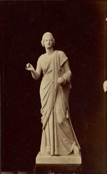 Unknown, [Statue of female figure holding round object]