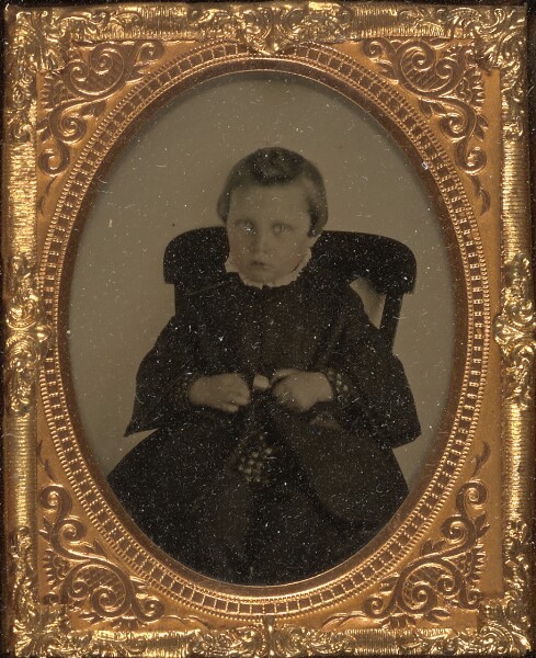 Unknown, [Little boy seated holding a bell]