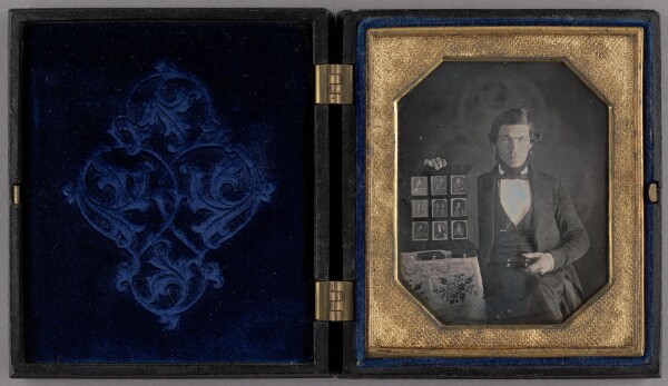 Unknown, Portrait of a Daguerreotypist Displaying Daguerreotypes and Cases
