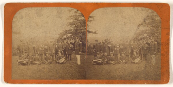 Unknown, [Musical group posed outside, some seated on ground]