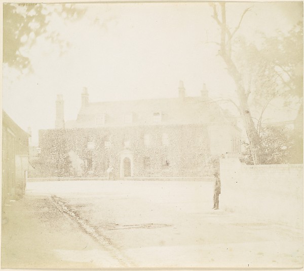 Unknown, [Man in Courtyard Before House]