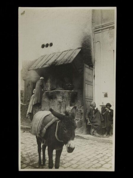 Unknown, A cafe in Kairouan, Algeria, with a donkey in the  foreground.