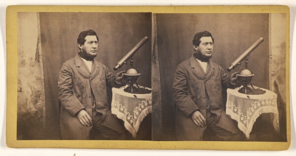 Unknown, [Unidentified man posed with small telescope on a table]
