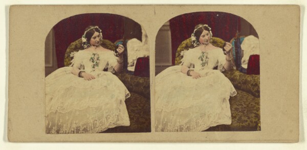 London Stereoscopic and Photographic Company, [Woman seated in enlongated chair admiring herself in a hand mirror]