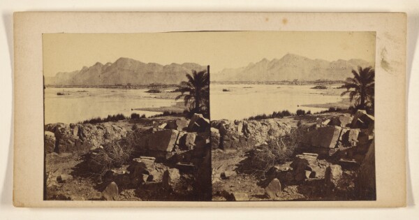 Francis Frith, [Rock piles near body of water, palm tree at right]