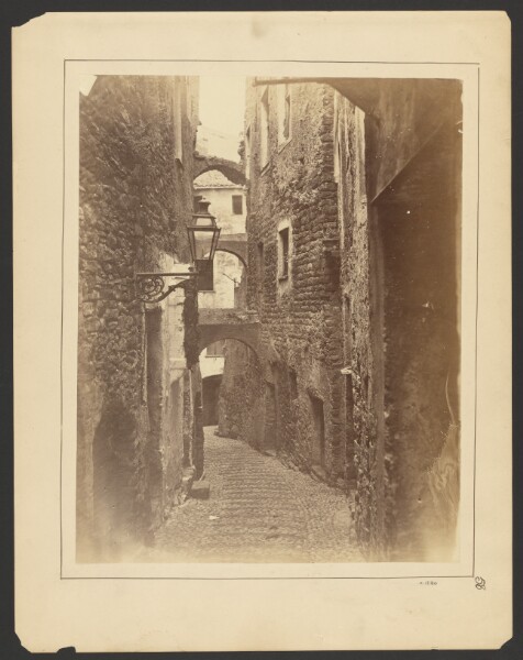 Unknown, [View down narrow street]