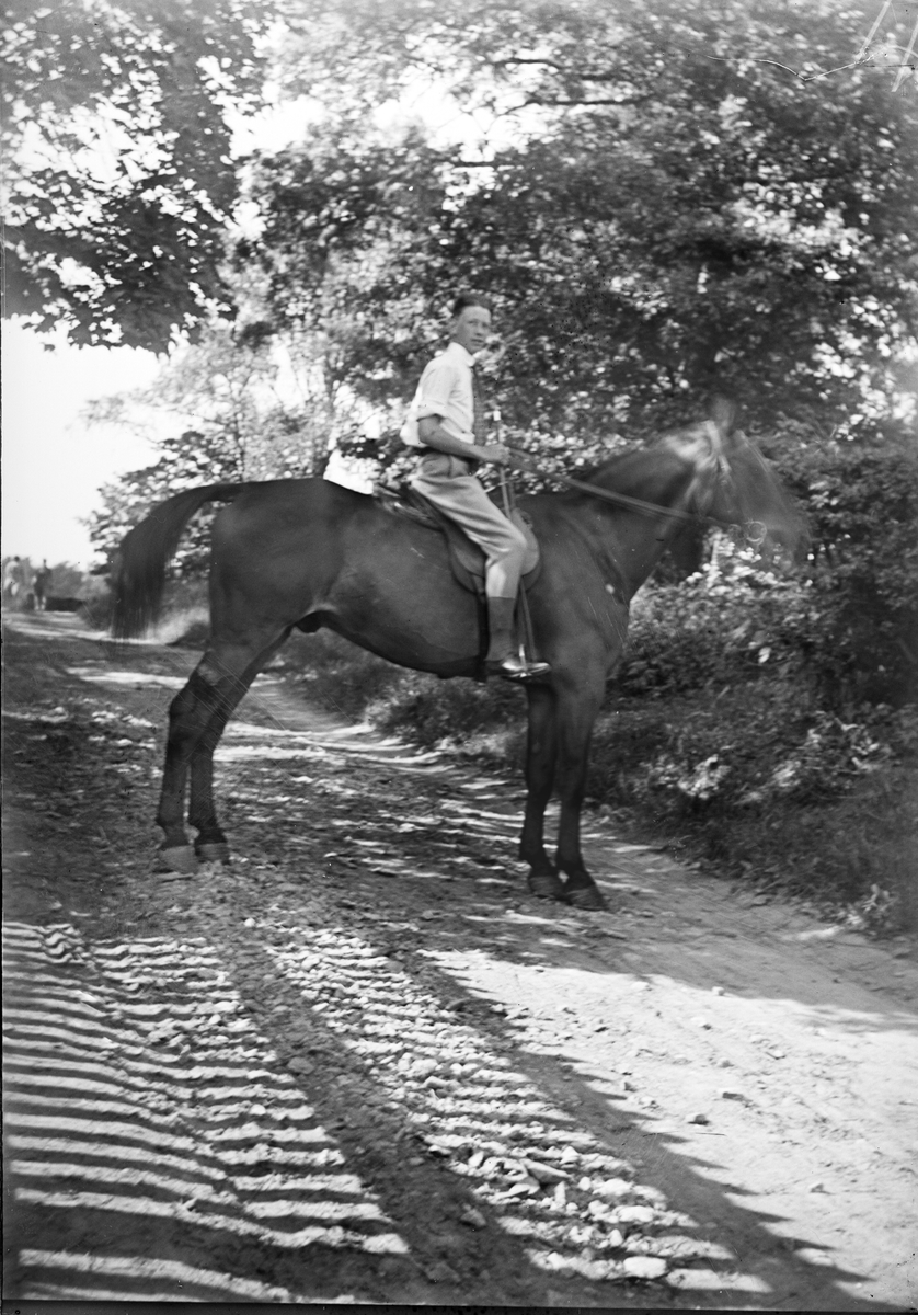 Okänd,, Young man riding a horse, likely in Sweden