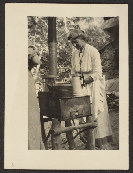 Louis Fleckenstein, [Woman Using Outdoor Stove]