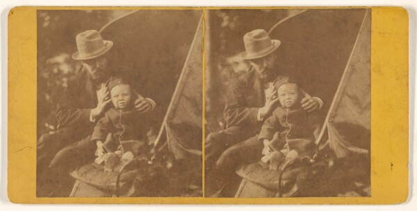 Unknown, [Bearded man in hat with child on his lap]