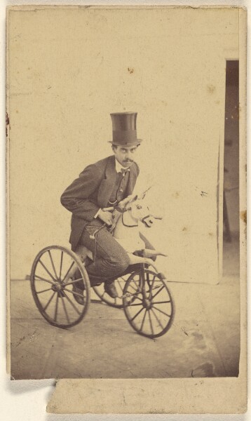 Unknown, [Man in a top hat riding a bicycle with a horse head]