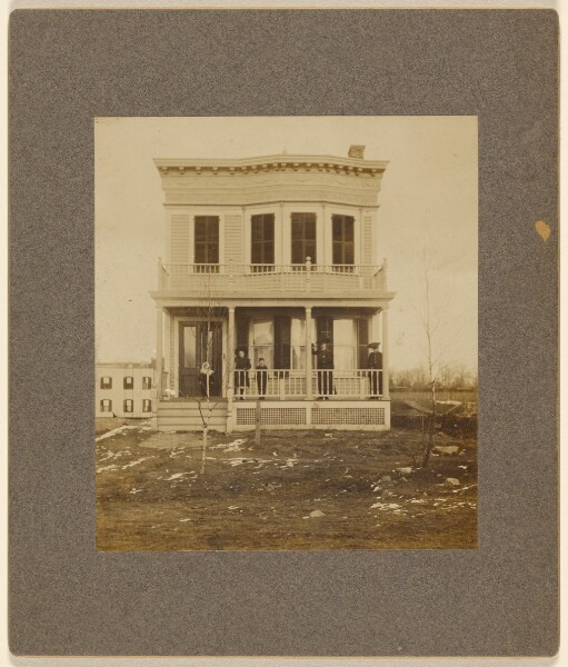 Unknown, [View of a Victorian-style house with five people on the front porch]