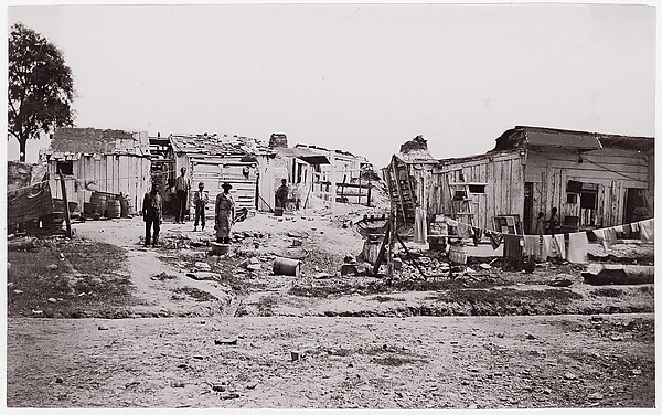 Unknown, [Encampment with shacks and laundry]