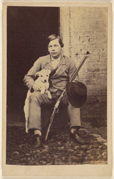 Unknown, [Man seated with a white dog, a rifle and hat leaning on his leg]