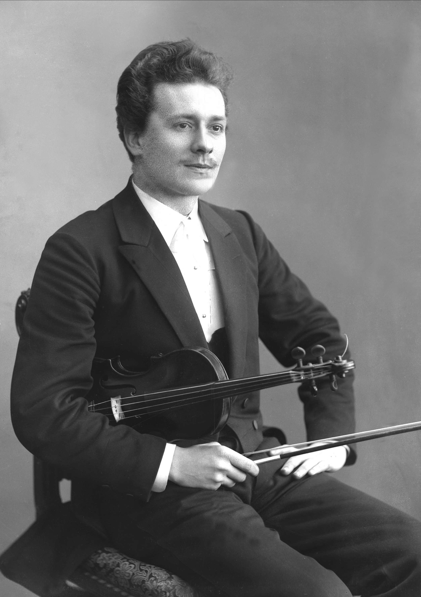 Gustav Borgen, Portrett, sittende mann med fiolin under armen. Frantz J Furicek.