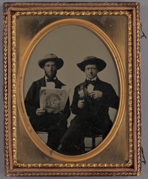 Unknown, [Portrait of two seated men wearing bow ties and hats]