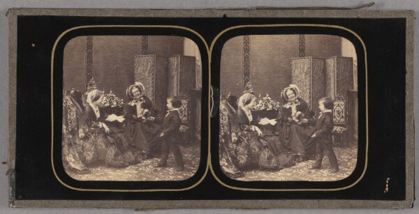 Unknown, [Two women seated, little boy presenting them with a bouquet of flowers]